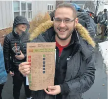  ?? CHRIS CHRISTO / HERALD STAFF ?? ORDER’S UP: Thomas Fogarty of Uxbridge holds a menu as he waits to enter the store.