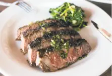  ?? Jen Fedrizzi / Special to The Chronicle 2016 ?? Niman Ranch’s rib eye is used in this dish with garlic greens and chimichurr­i at Atwater Tavern in San Francisco.