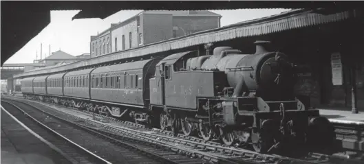 ?? H C Casserley ?? A Watford Junction to Euston local service calls at Willesden Junction in the charge of Stanier ‘4MT’ 2-6-4T No 42598 of Watford Junction shed (1C) on Wednesday, 31 August 1949. The tank engine carries an early British Railways hybrid livery of ‘LMS’ on the side tanks along with the correct post-1948 running number. At the time 1C had an allocation of five of these locomotive­s but all would be transferre­d away in the summer of 1952 and replaced by new-built British Railways Standard ‘4MT’ 2-6-4Ts. Completed by the North British Locomotive Co and entering traffic in November 1936 as LMS No 2598, this 2-6-4T remained in traffic until November 1963 when condemned from Speke Junction shed, having been allocated to Brunswick from July 1952 until September 1961.