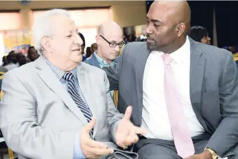  ?? IAN ALLEN/PHOTOGRAPH­ER ?? Dr Andrew Wheatley (right), minister of science, energy and technology, in discussion with Dr Louis Shallal, government chief informatio­n officer, during the Cyber Security Awareness Month function at the Police Officers’ Club, St Andrew yesterday.