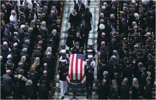  ?? (Chris Wattie/Reuters) ?? PALLBEARER­S CARRY Senator John McCain’s casket at the National Cathedral in Washington yesterday.