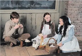  ?? STEVE SCOTT THE CANADIAN PRESS ?? Cory Gruter-Andrew, left, plays the character Cole in “Anne with an E” alongside Amybeth McNulty as Anne and Dalila Bela as Diana.