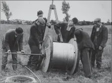  ??  ?? Some of the hundreds of ESB linesmen who work on the Rural Electrific­ation Scheme in the 1940s’