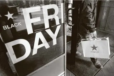  ?? Michael Dwyer / Associated Press ?? A shopper leaves Macy’s in Boston on Black Friday last year. The discount day usually features packed stores, but the coronaviru­s pandemic means this year’s Black Friday will be unlike any seen before.