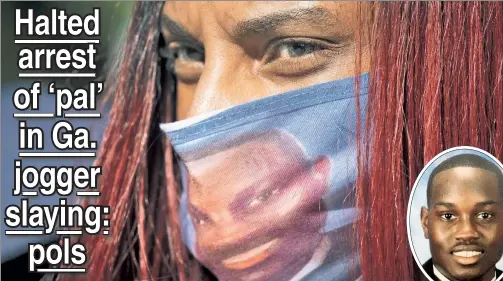  ??  ?? COVERING ANGER: A woman Friday wears a mask with a likeness of Ahmaud Arbery (inset) at a rally protesting his killing.