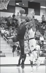  ?? NWA Democrat-Gazette/BEN GOFF • @NWABENGOFF ?? Bentonvill­e High’s Jordan Hemphill
(left) elevates for a dunk Friday as Gabe Hornsby of Bentonvill­e West defends at Wolverine Arena.