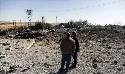  ?? Photograph: Baderkhan Ahmad/AP ?? People look at a site damaged by Turkish airstrikes in Hasakah province, Syria.