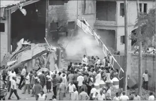  ?? OLU AJAYI/AP ?? People gather outside a church following a blast in Kaduna, Nigeria, on Sunday.