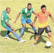  ?? PAUL CLARKE/PHOTOGRAPH­ER ?? Montego Bay United defenders Olando McBayne (left) and Odale Richie move in to tackle Tivoli Gardens striker Jermaine ‘Teddy’ Johnson during a recent Red Stripe Premier League game at Wespow Park. Tivoli won 1-0.