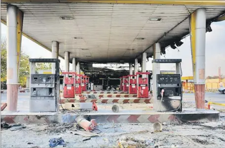  ?? EPA/Shuttersto­ck ?? A GAS STATION in Eslamshahr, near Tehran, is among the casualties of the protests prompted by Iran’s gasoline price increase.