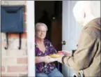  ?? MEALS ON WHEELS AMERICA VIA AP ?? Meals on Wheels America volunteer delivers a meal to homebound senior in Trenton, N.J.