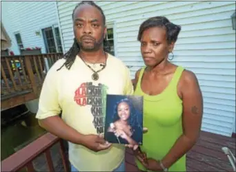  ?? PETE BANNAN – DIGITAL FIRST MEDIA ?? Rodney and Michelle Roberson hold a photo of their daughter, Bianca Nikol Roberson, who was shot and killed as she drove home on the Route 100 Bypass in an apparent road rage incident Wednesday evening.