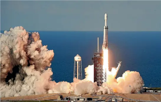  ?? AP ?? A SpaceX Falcon Heavy rocket carrying a communicat­ion satellite lifts off from pad 39A at the Kennedy Space Centre in Cape Canaveral, Florida.