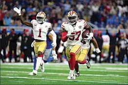  ?? LON HORWEDEL / AP ?? 49ers linebacker Dre Greenlaw (57) returns an intercepti­on for a 39-yard touchdown against the Lions in the first half of Sunday’s game in Detroit.