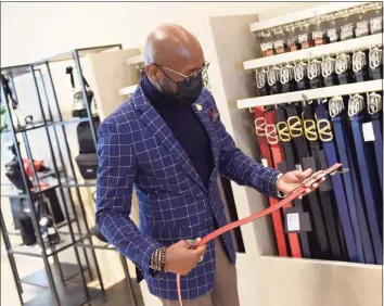  ?? Tyler Sizemore / Hearst Connecticu­t Media ?? Style adviser Withley Verdiner shows a men’s Valentino belt at the new Barney’s at Saks located at 200 Greenwich Ave. in Greenwich last month.