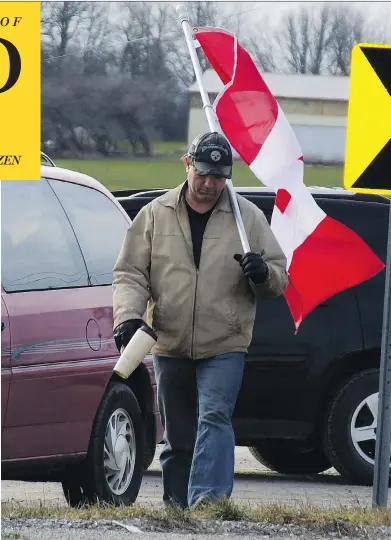  ??  ?? Randy Fleming’s act of protest — to carry a flag near a rally in Caledonia, Ont. — was forcibly stopped by six OPP officers.