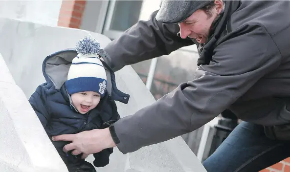  ?? MICHELLE BERG ?? Cayde Musselman and his grandfathe­r are all smiles as he heads down the ice slide during WinterShin­es at the Saskatoon Farmers’ Market on Sunday.