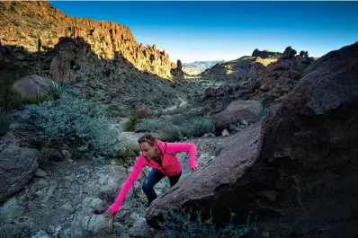  ?? Staff photo by Danielle Dupree ?? Anne-Mieke Broekman makes her way up the Grapevine Hills trail as the morning sun creeps into the valley below in Big Bend National Park,more than 700 miles southwest of Texarkana.