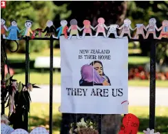  ??  ?? 3 A poster hangs at a memorial site for victims of Friday’s shooting, in front of Christchur­ch Botanic Gardens