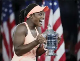  ?? JULIO CORTEZ — THE ASSOCIATED PRESS ?? Sloane Stephens, of the United States, holds up the championsh­ip trophy after beating Madison Keys in the women’s singles final of the U.S. Open tennis tournament, Saturday in New York.