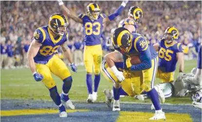  ?? SEAN M. HAFFEY/GETTY IMAGES ?? Rams running back C.J. Anderson celebrates after scoring from one yard out in the fourth quarter.