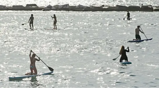  ?? Picture: AFP ?? People paddle boarding at dawn at La Barcelonet­a Beach in Barcelona yesterday as the country slowly loosens a strict coronaviru­s lockdown.