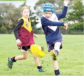  ??  ?? Above: Nyora’s William Lineham tackles Warragul Blues’ Isaac Hughes in the WDJ under 10s.
Left: Noah Young boots the Warragul Blues into attack against Nyora during the under 10 game on Saturday morning.
Warragul Blues won 92-0.