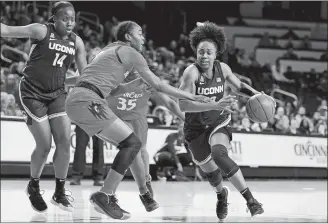  ?? GARY LANDERS/AP PHOTO ?? UConn guard Christyn Williams, right, drives against Cincinnati guard Jada Scott, left, during the second half of Wednesday’s game in Cincinnati.