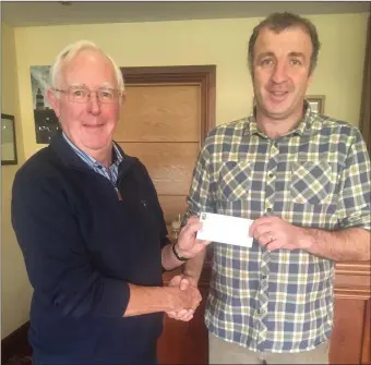  ??  ?? Liam Foley handing over a cheque for €2,600 to Jack Nolan, chair of Duncannon NS Parents Associatio­n following this year’s sand sculpting festival.