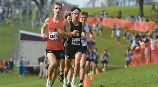  ?? BRIAN KRISTA/BALTIMORE SUN ?? Dulaney’s Tyler Dailey leads Richard Montgomery’s Noah Fisher and other runners in the Class 4A boys race Saturday at Hereford.
