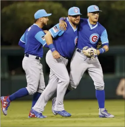  ?? LAURENCE KESTERSON — THE ASSOCIATED PRESS ?? Cubs center fielder Albert Almora Jr. (5), left fielder Kyle Schwarber, center, and second baseman Javier Baez embrace after they defeated the Phillies 17-2 Saturday.