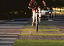  ?? Elizabeth Conley / Houston Chronicle ?? The Dutch Junction on the campus of Texas A&M provides one crossing lane for cyclists and another for pedestrian­s. Stop signs for vehicular traffic are placed back from the intersecti­on for increased visibility.