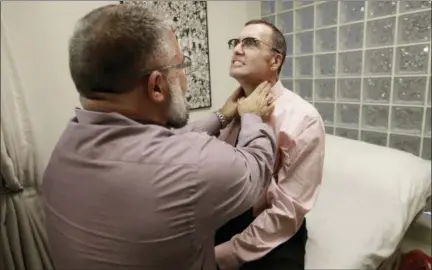  ?? JEFF CHIU — THE ASSOCIATED PRESS ?? On Jan. 26, Matt Chappell, right, is checked by Dr. Christophe­r Schiessl during an appointmen­t at a medical center in San Francisco. For more than a decade, the strongest AIDS drugs could not fully control Chappell’s HIV infection. Now his body does it...