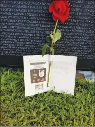  ?? PHOTO COURTESY VVMF ?? Visitors to the Vietnam Veterans Memorial in Washington, D.C., and the traveling Wall That Heals leave tributes of many kinds to the fallen servicemen named there.