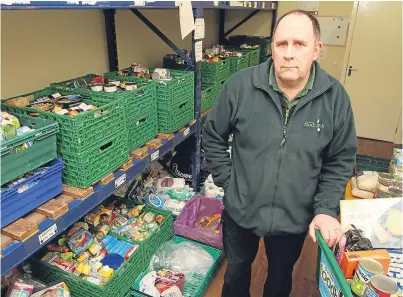  ??  ?? Ken Linton with supplies ready for clients at Dundee Foodbank.