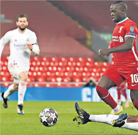  ??  ?? They shall not pass: Real Madrid centre-back Eder Militao makes a tackle to thwart Sadio Mane