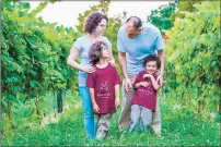  ?? Kori Andrea Photograph­y / Contribute­d photo ?? Neviana Zhgaba and her husband, Ardian Llomi, with their sons, are owners of Aquila’s Nest Vineyards in Newtown.