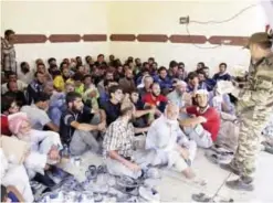  ??  ?? MOSUL: In this Aug 12, 2017 photo, civilian men from the Iraqi town of Tal Afar wait to undergo security screening at a collection point for displaced people. —AP