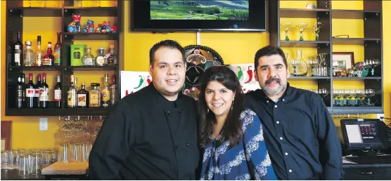  ?? JIM WELLS ?? Hector Delgado Jr., from left, Diana Palafox and Hector Delgado Sr. have brought Tu Tierra Mexican Restaurant back to the culinary scene, at 8995 Bonaventur­e Dr. SE.