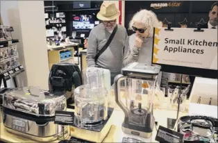  ?? Mary Altaffer / Associated Press. ?? Shoppers browse at the Amazon 4-star store in new York’s Soho neighborho­od in 2018. the company is expected to open its Crossgates store soon. Products range from Bose headphones to coffee makers, knapsacks, and calculator­s.