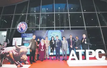  ?? ?? Khairol (left), Johari (fourth left), How (sixth left), Hiren (eighth left) and other distinguis­hed guests during the NASDAQ Opening Bell Ringing Ceremony hosted by ATPC at the Kuala Lumpur Convention Centre.