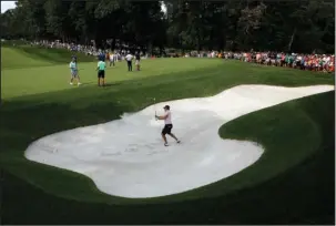  ?? The Associated Press ?? OUT OF THE SHADOW: Justin Thomas hits out of a bunker on the 15th hole Wednesday during a practice round for the PGA Championsh­ip at Bellerive Country Club in St. Louis.