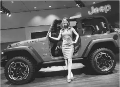  ?? Frederic J. Brown/afp/ Getty Images ?? Chrysler didn’t go all green in L. A., choosing instead to show off its new Jeep Wrangler 10th anniversar­y Rubicon edition.