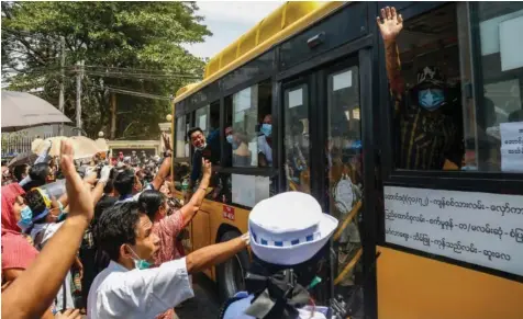  ?? — AFP ?? Family members greet prisoners being freed from Yangon’s Insein prison on Friday.