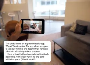  ?? (Wayfair via AP) ?? This photo shows an augmented reality app, WayfairVie­w in action. The app allows shoppers to visualize furniture and decor in their homes at full-scale before they make a purchase.
Here, a chair that has been selected is virtually placed in a room to...