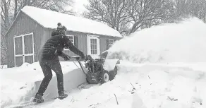  ??  ?? Ben Jennings snowblows his driveway on Sunday, in Glenville, N.Y., where 16 inches of snow fell. MARY ESCH/AP