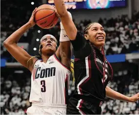  ?? Jessica Hill/Associated Press ?? UConn’s Aaliyah Edwards (3) shoots as South Carolina’s Victaria Saxton defends in the first half Sunday in Hartford.