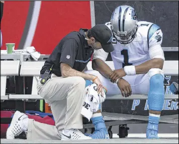  ??  ?? The Panthers said Cam Newton hurt his passing shoulder Dec. 11 against the Chargers. The quarterbac­k was limited in practice but played the final three games of 2016.