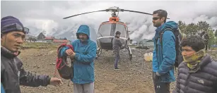  ?? LAUREN DECICCA/NEW YORK TIMES ?? Trekkers stop at the airport in Lukla, Nepal, before beginning their trip to the Everest base camp on May 3. Some disreputab­le Himalayan trek operators, guides, helicopter evacuation companies and hospitals have conspired to bilk insurance companies.