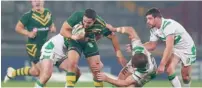  ?? Getty Images ?? Jarryd Hayne of Australia charges through Tyrone McCarthy and Rory Kostjasyn of Ireland. —